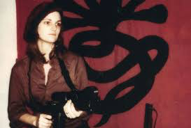 Patty Hearst, holding up a bank with the Symbionese Liberation Army